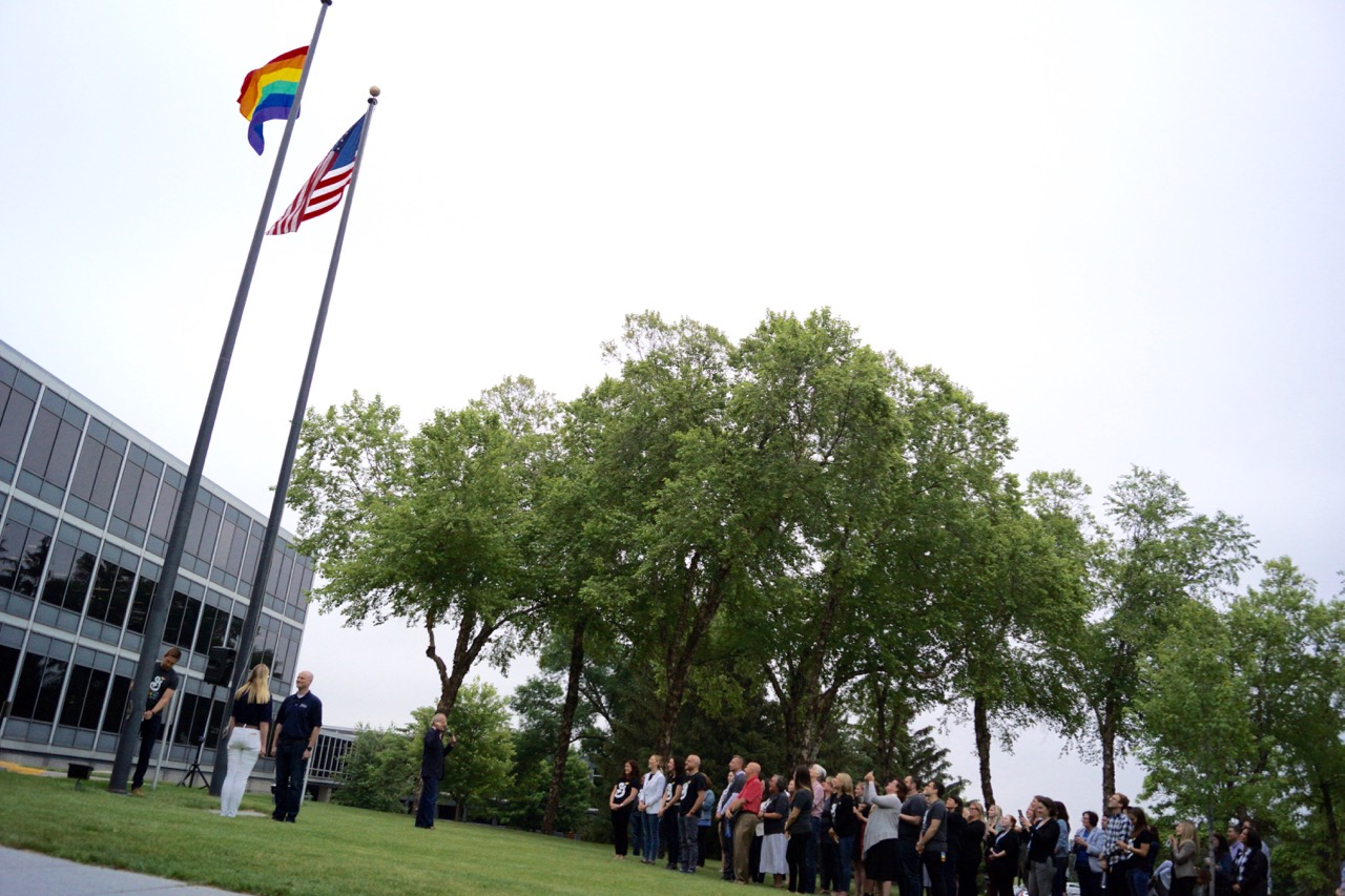 Employees watching Pride Flag being raised