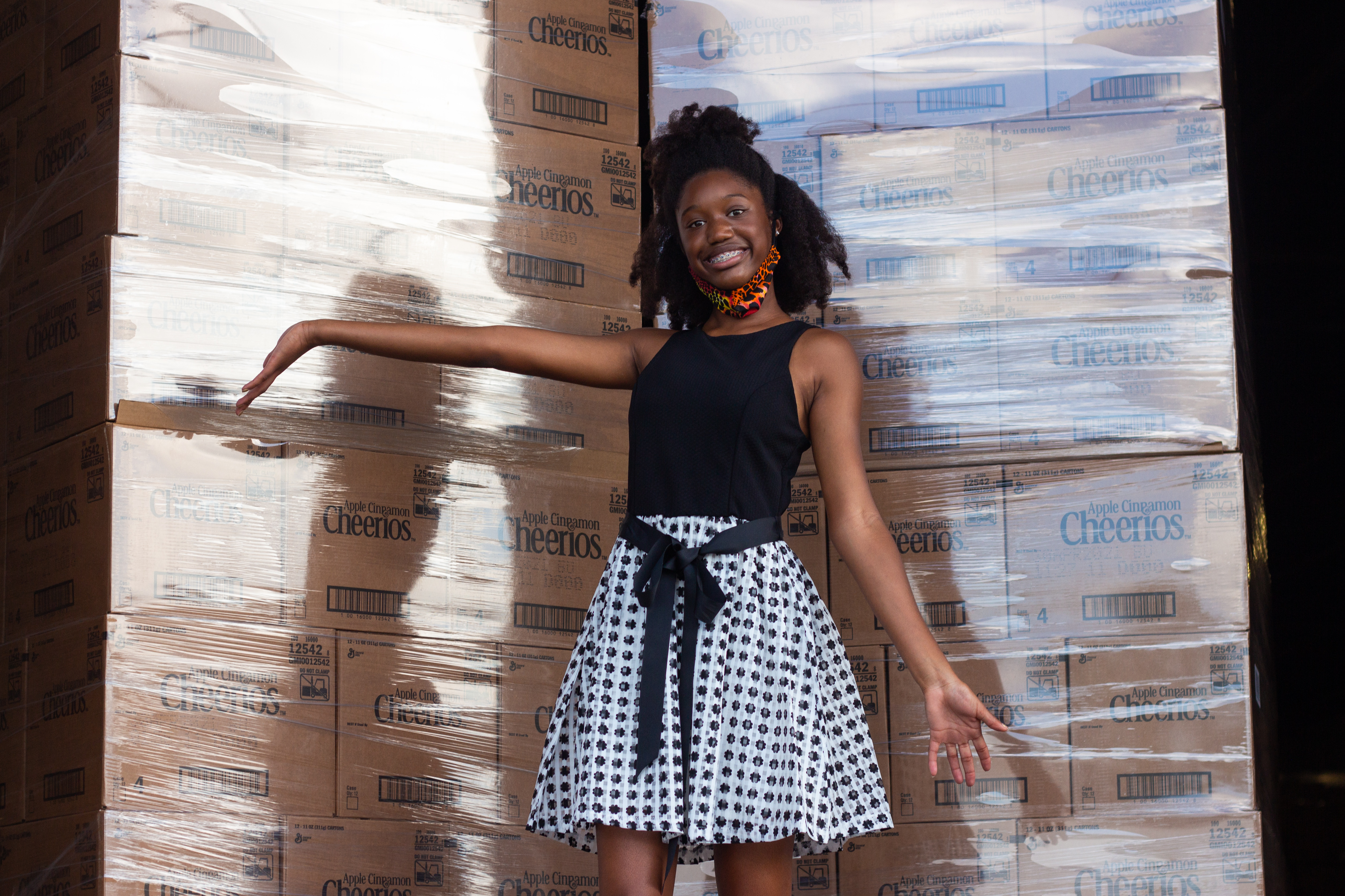 Kennedy McCormick standing in front of cereal box pallets