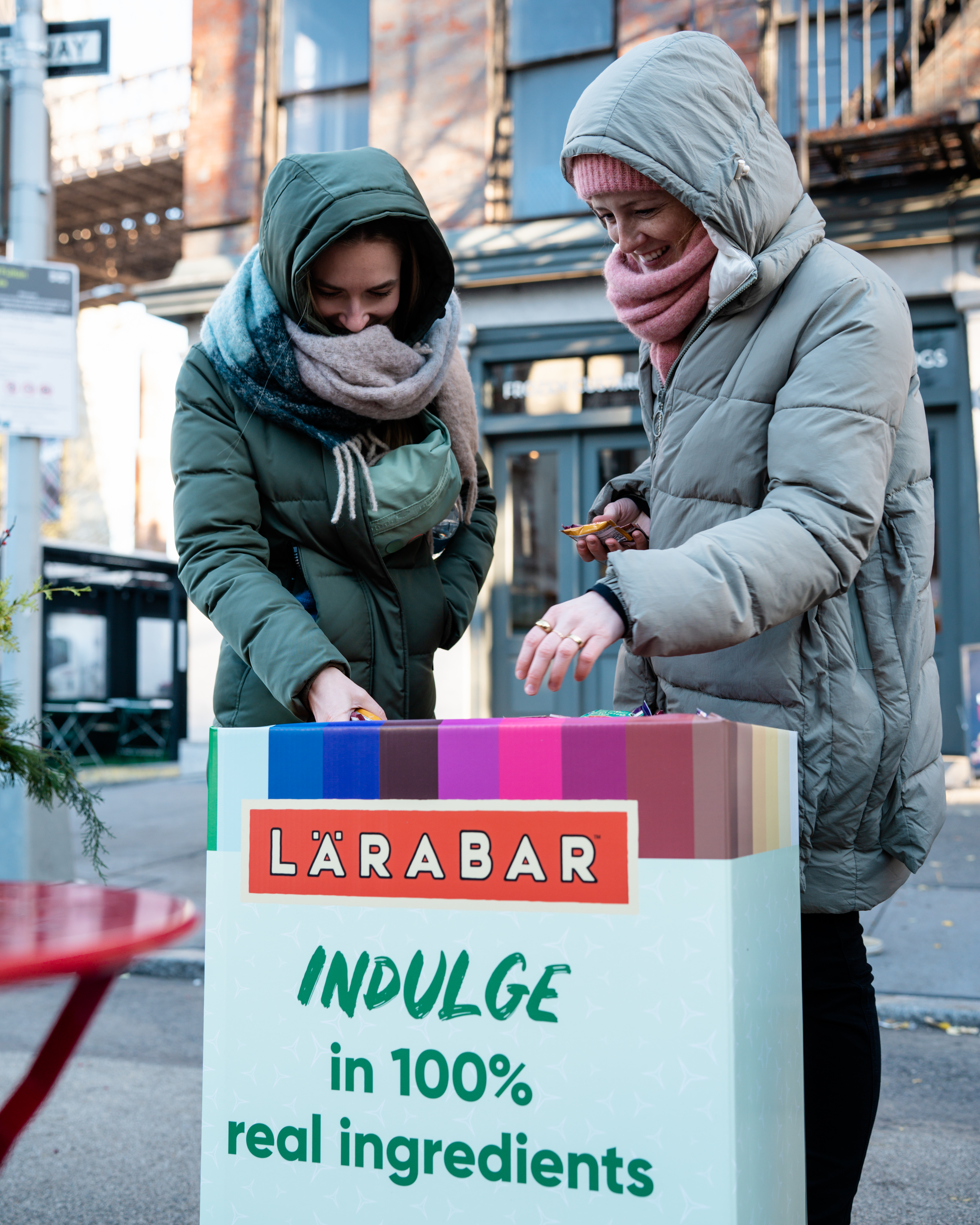 Two women choosing a Larabar flavor
