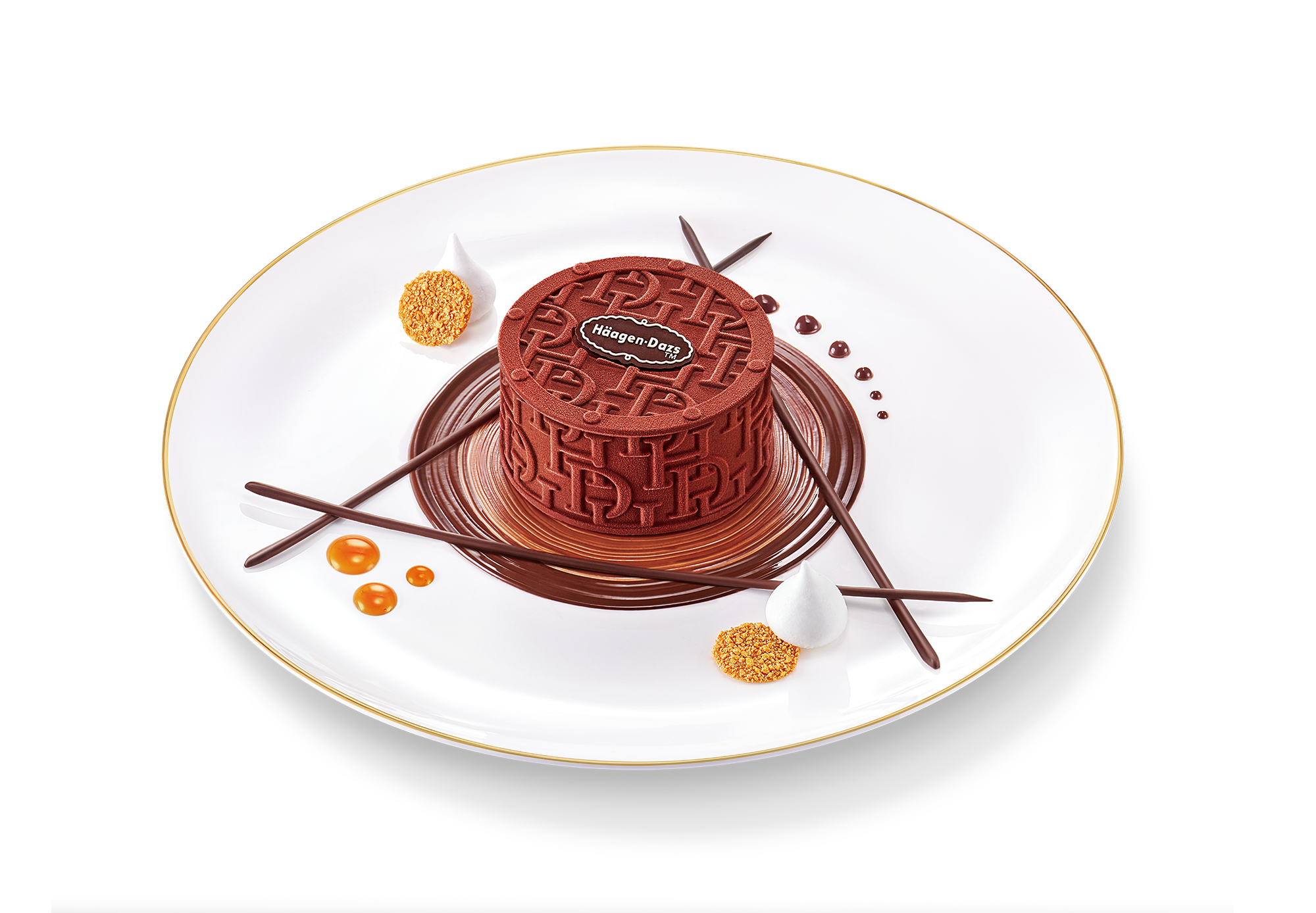 Häagen-Dazs ice cream mooncake with embossed HD monogram on the velvety chocolate ganache coating with branded logo embellishment elegantly presented on a white plate decorated with chocolate swirls, small dots of caramel, and delicate meringues. 