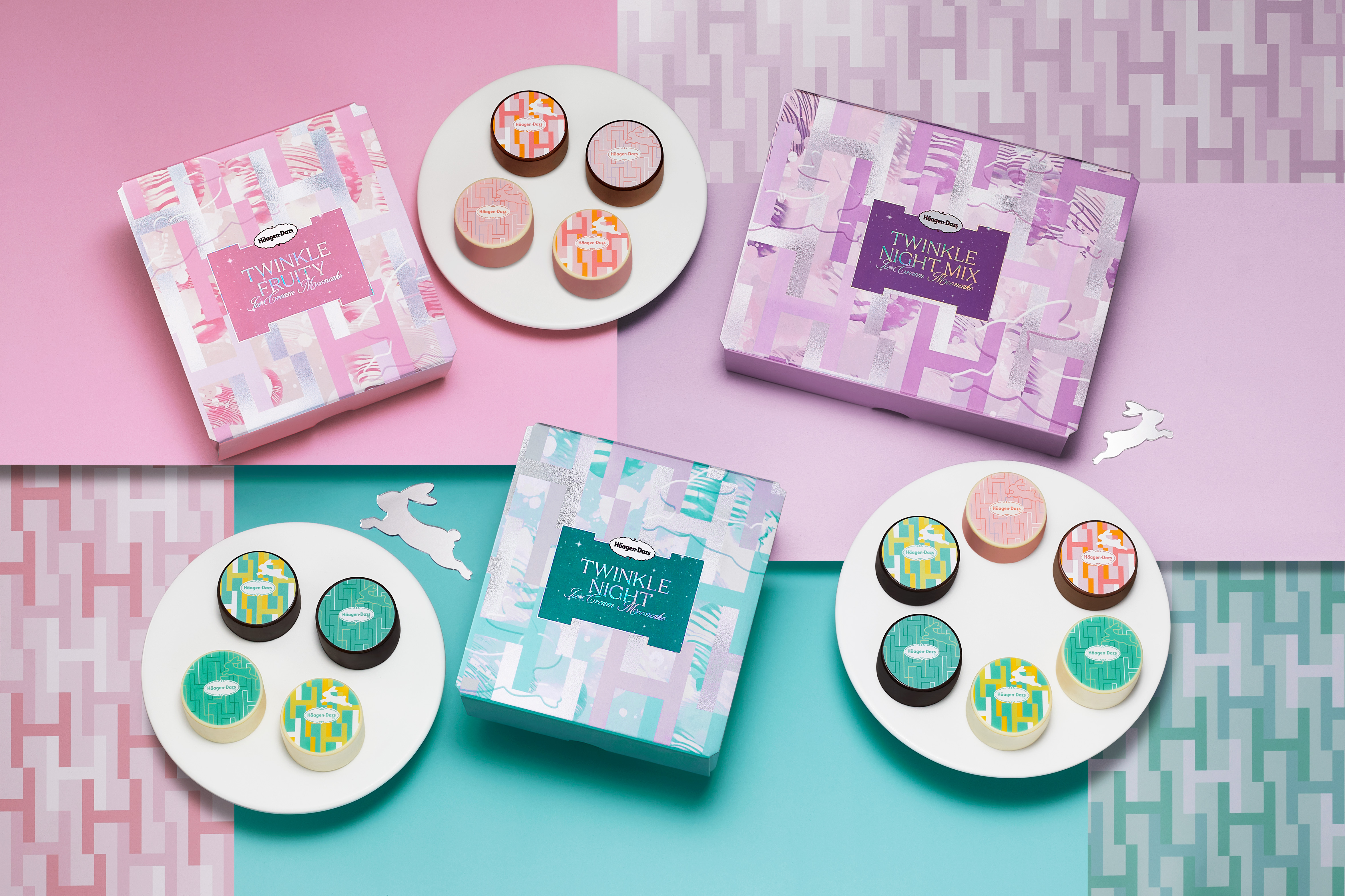 Assortment of Häagen-Dazs Hong Kong's Mid-Autumn Festival Twinkle gift boxes aside three white plates displaying an assortment of ice cream mooncakes, against a geometric patterned background in shades of pink, purple and teal.